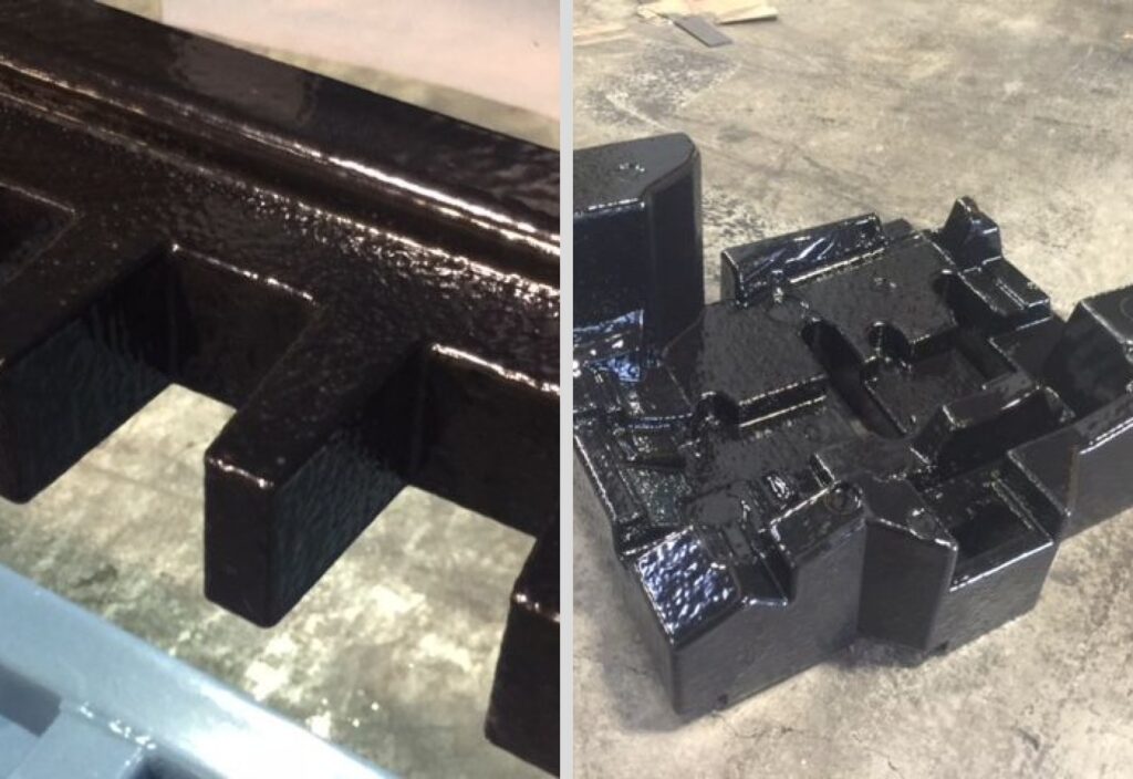 Two pieces of foam dunnage finished with a glossy black polyurea protective coating