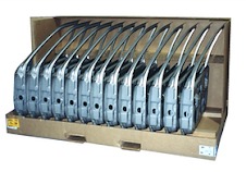 Row of stamped sheet metal panels standing in a corrugated tray